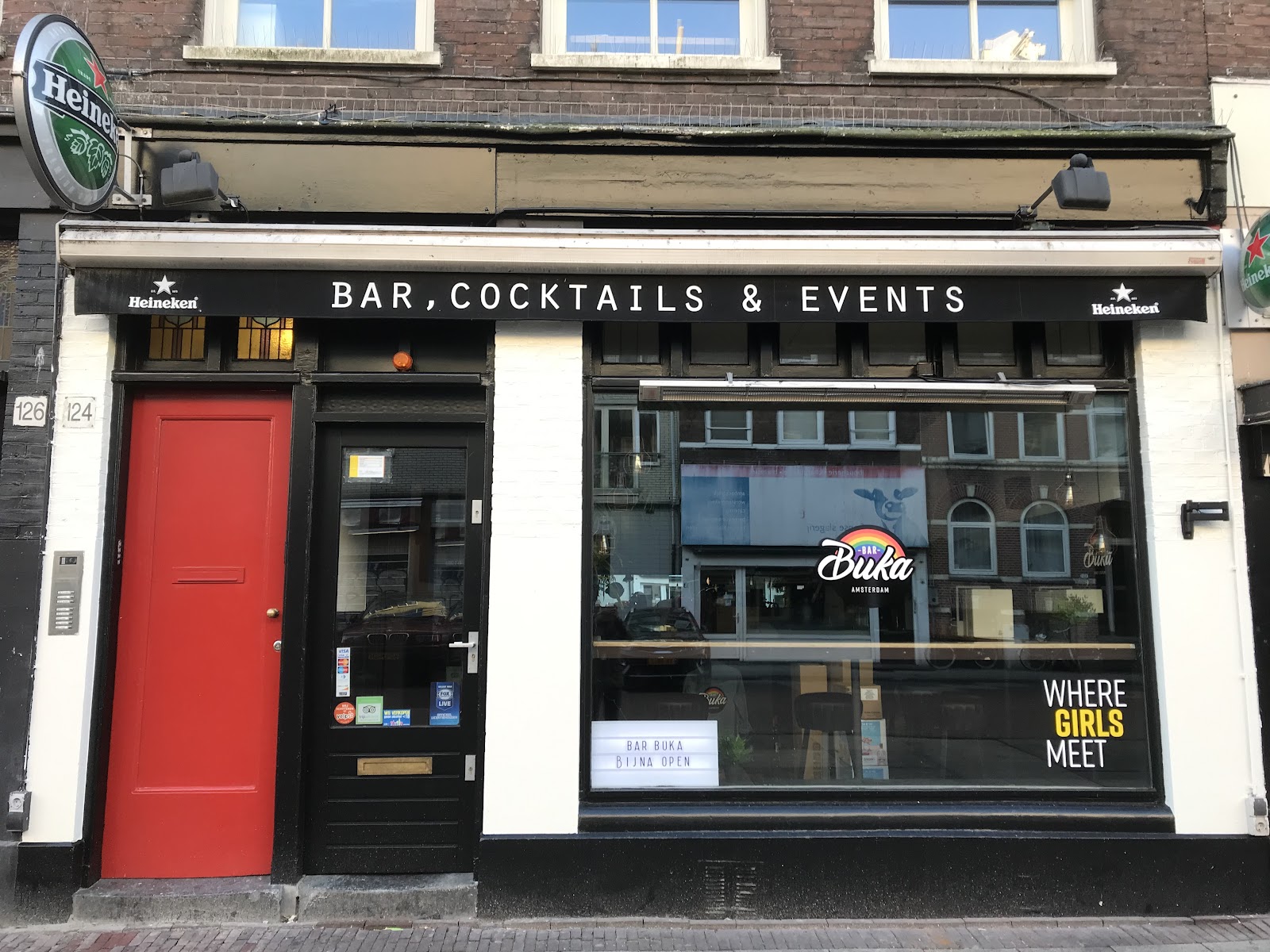 Low-lit cocktail bar interior with a stocked back bar at Bar Buka in De Pijp, Amsterdam