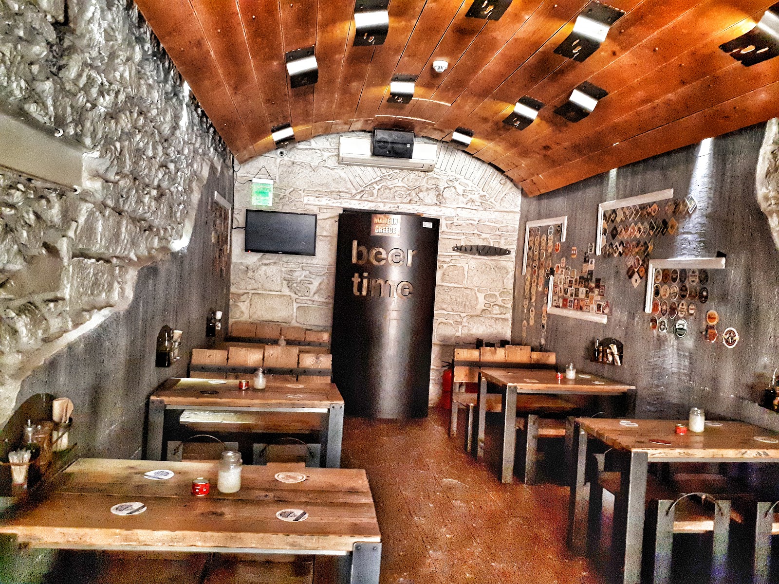 Rows of craft beer taps and glasses at Beer Time on Iroon Square in Psyrri, Athens