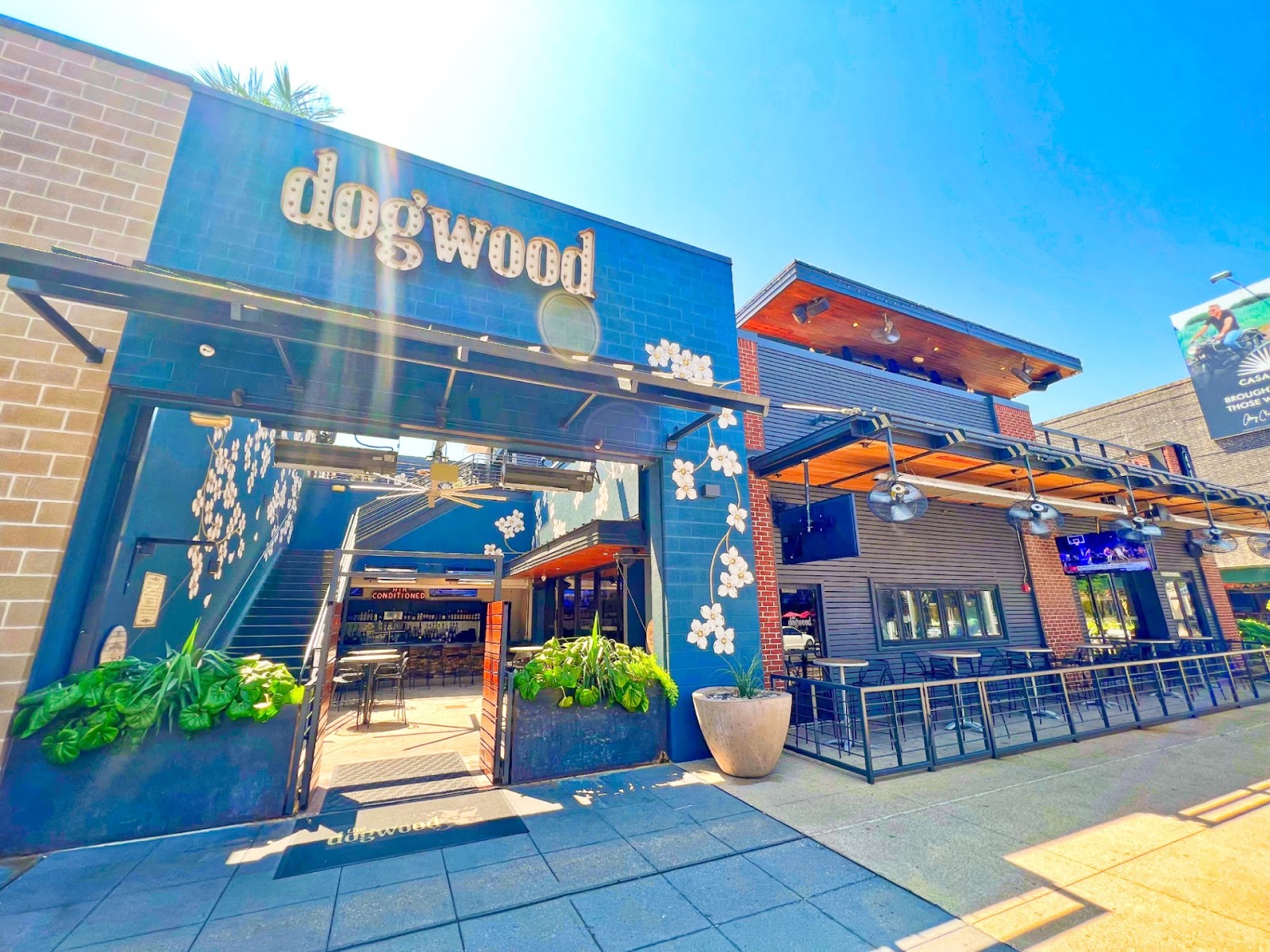 The Dogwood Domain indoor-outdoor sports bar with screens, Rock Rose Austin