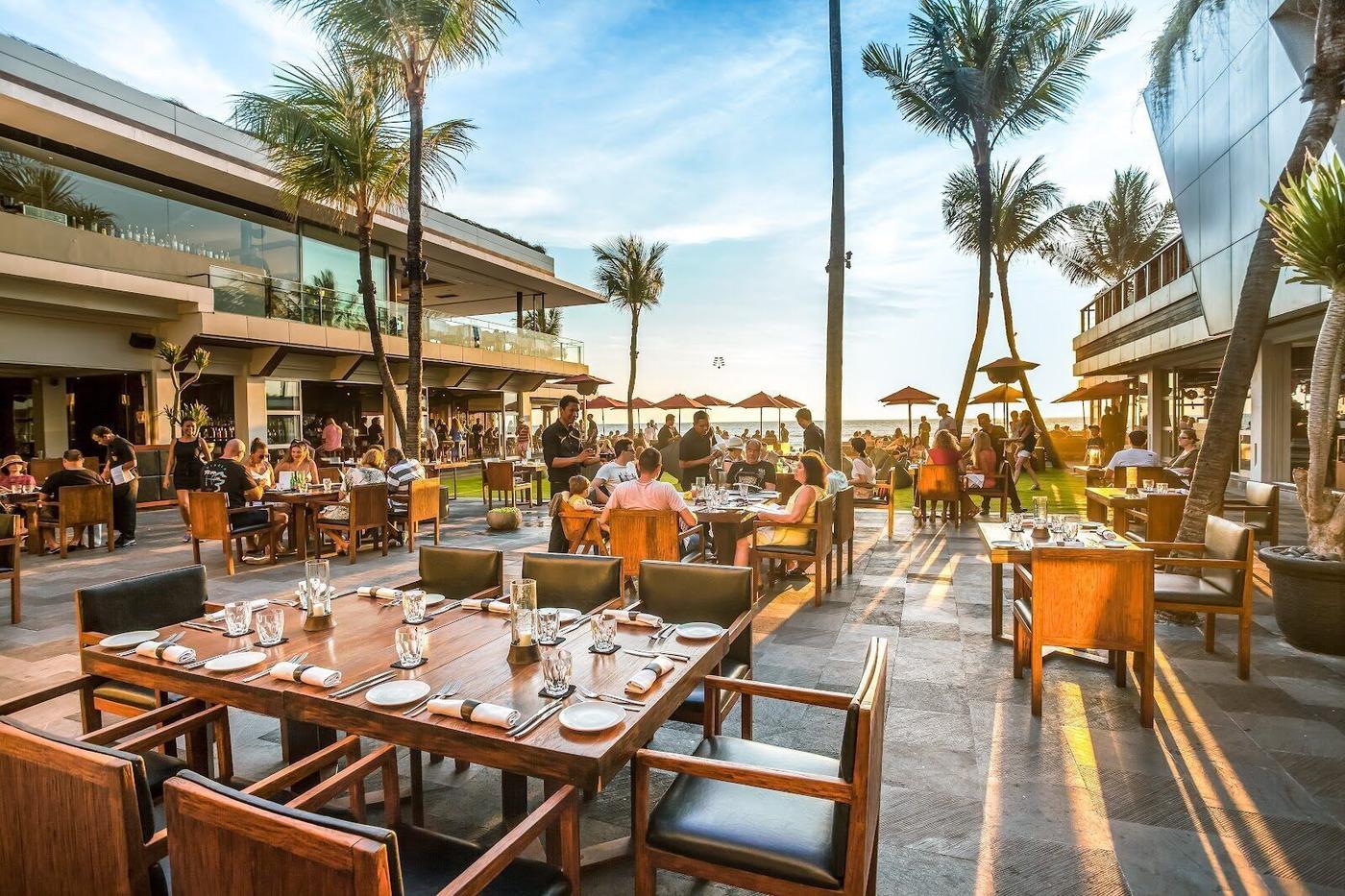 KU DE TA beach club at sunset, Seminyak Bali, infinity pool and cocktails overlooking the Indian Ocean