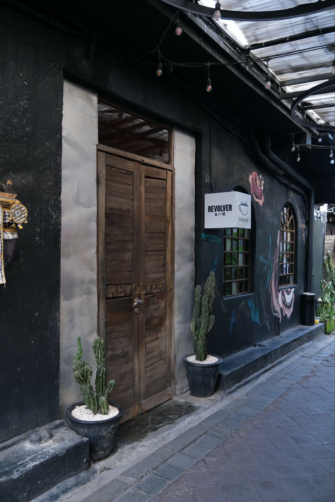 Revolver bar interior, Seminyak Bali, intimate speakeasy cocktail bar with low lighting and exposed brick