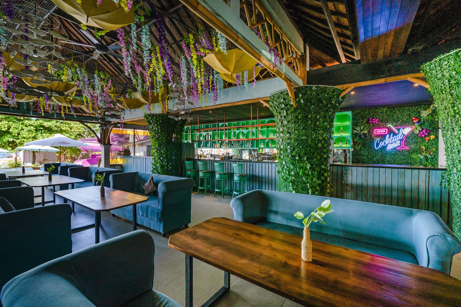 Casual pub tables under a thatched roof near the beach