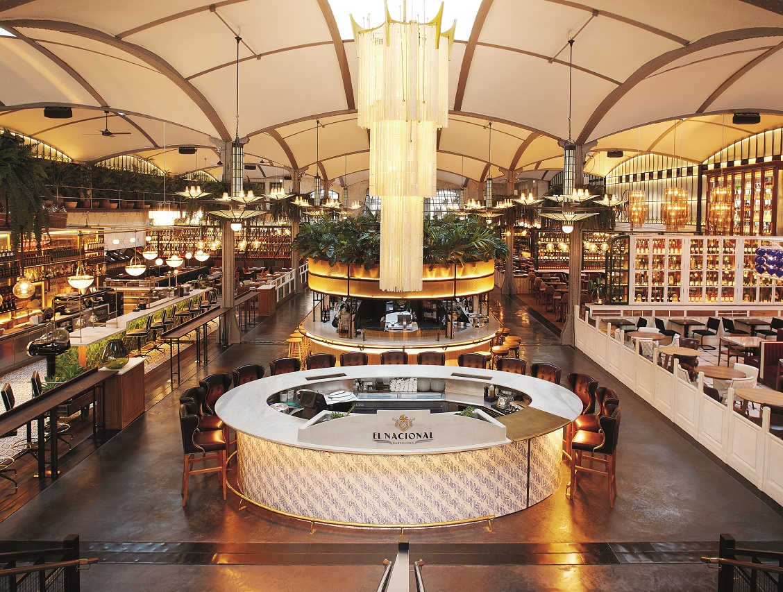 Grand restored theatre food hall with arched ceilings and several bars in Eixample Barcelona