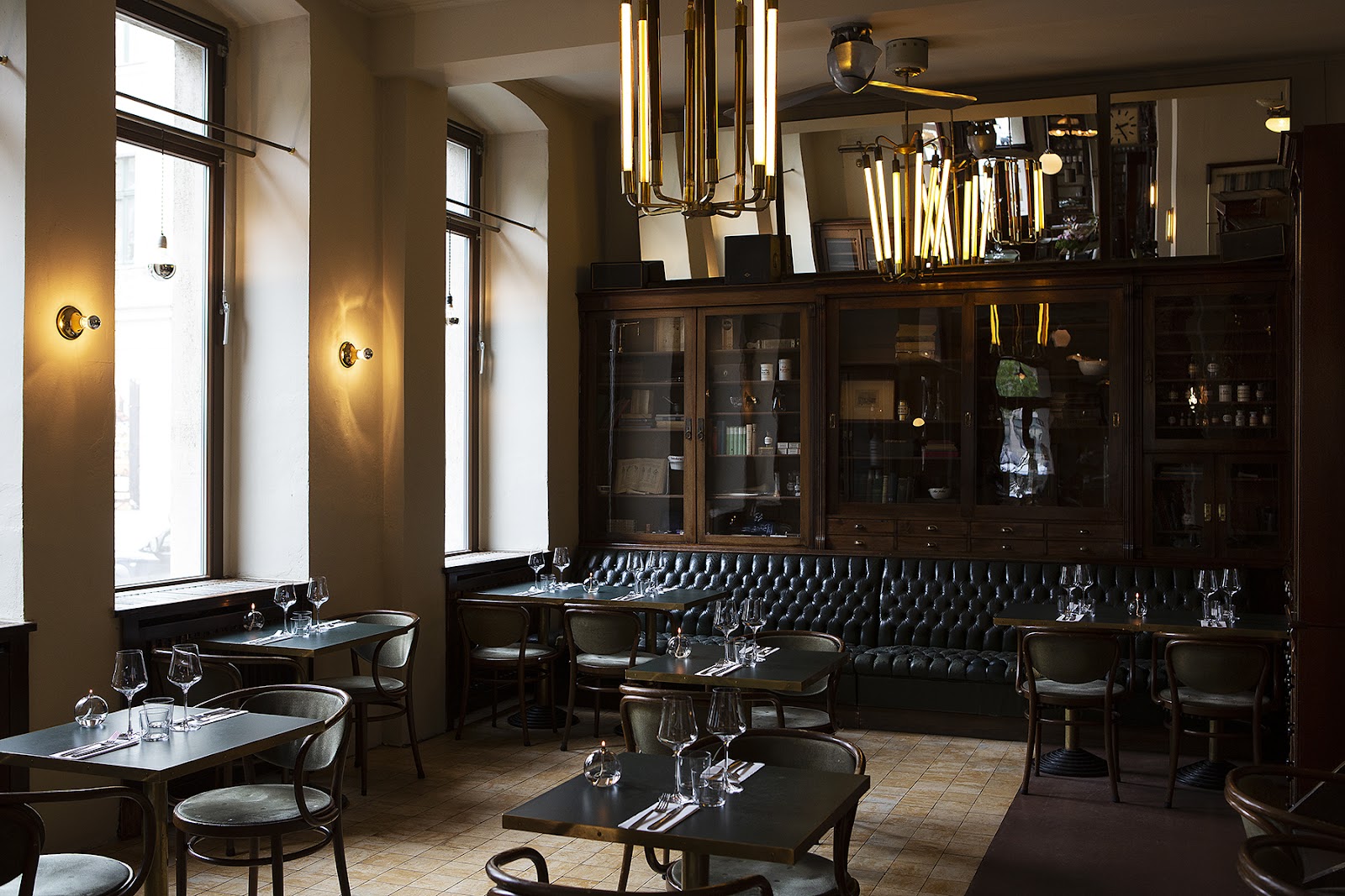 Tall wooden cabinetry and bottle shelves at a former pharmacy bar like Ora in Kreuzberg Berlin