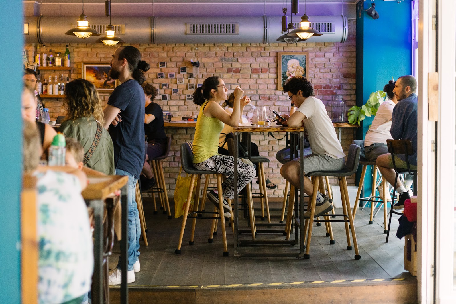 A row of craft beer taps against bright tiles at Protokoll, Berlin