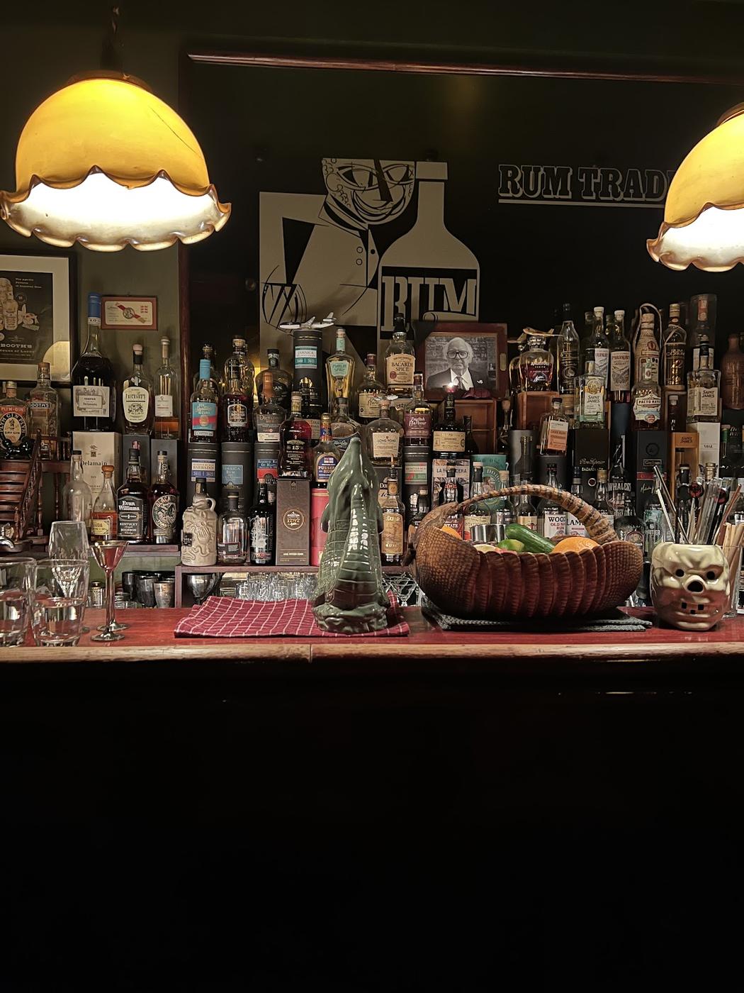 Rum Trader bar interior with dark wood and amber lighting