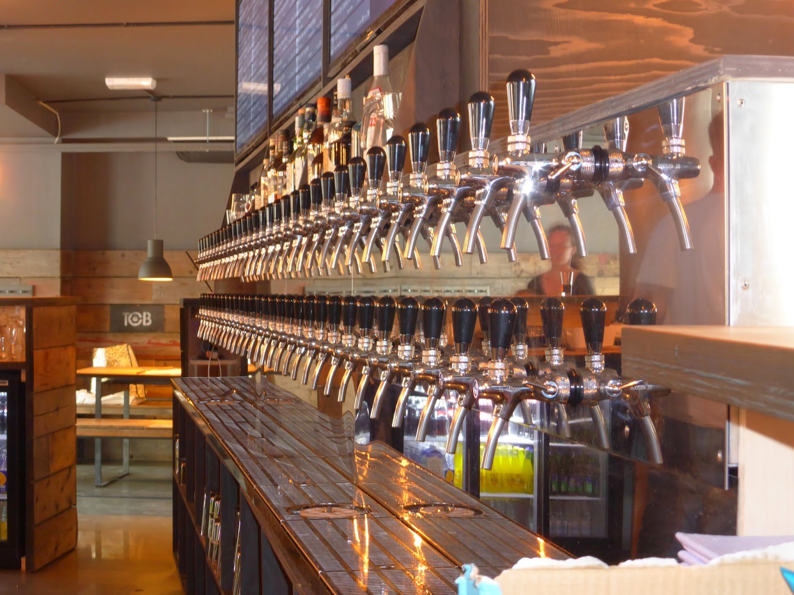 Long bar with many taps and bottles, similar in feel to Taphouse Copenhagen