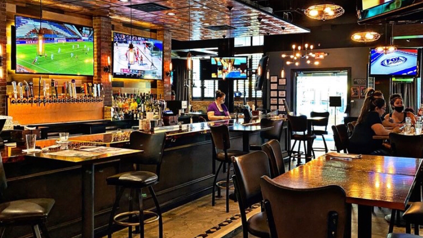 Frankie's Downtown sports bar interior with screens on Main Street in Dallas