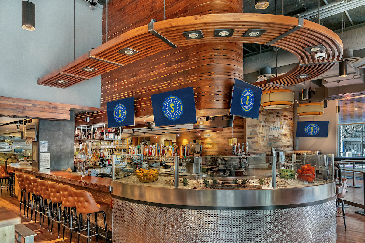 Stout Street Social downtown Denver bar with taps and screens