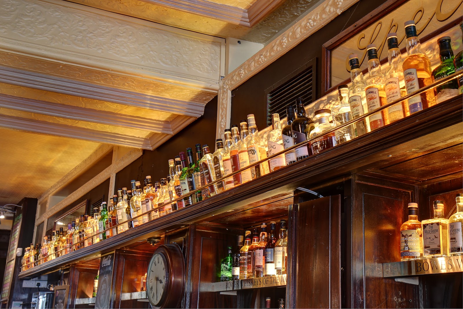 Backlit whiskey shelf in a Victorian Dublin bar at Bowe's on Fleet Street