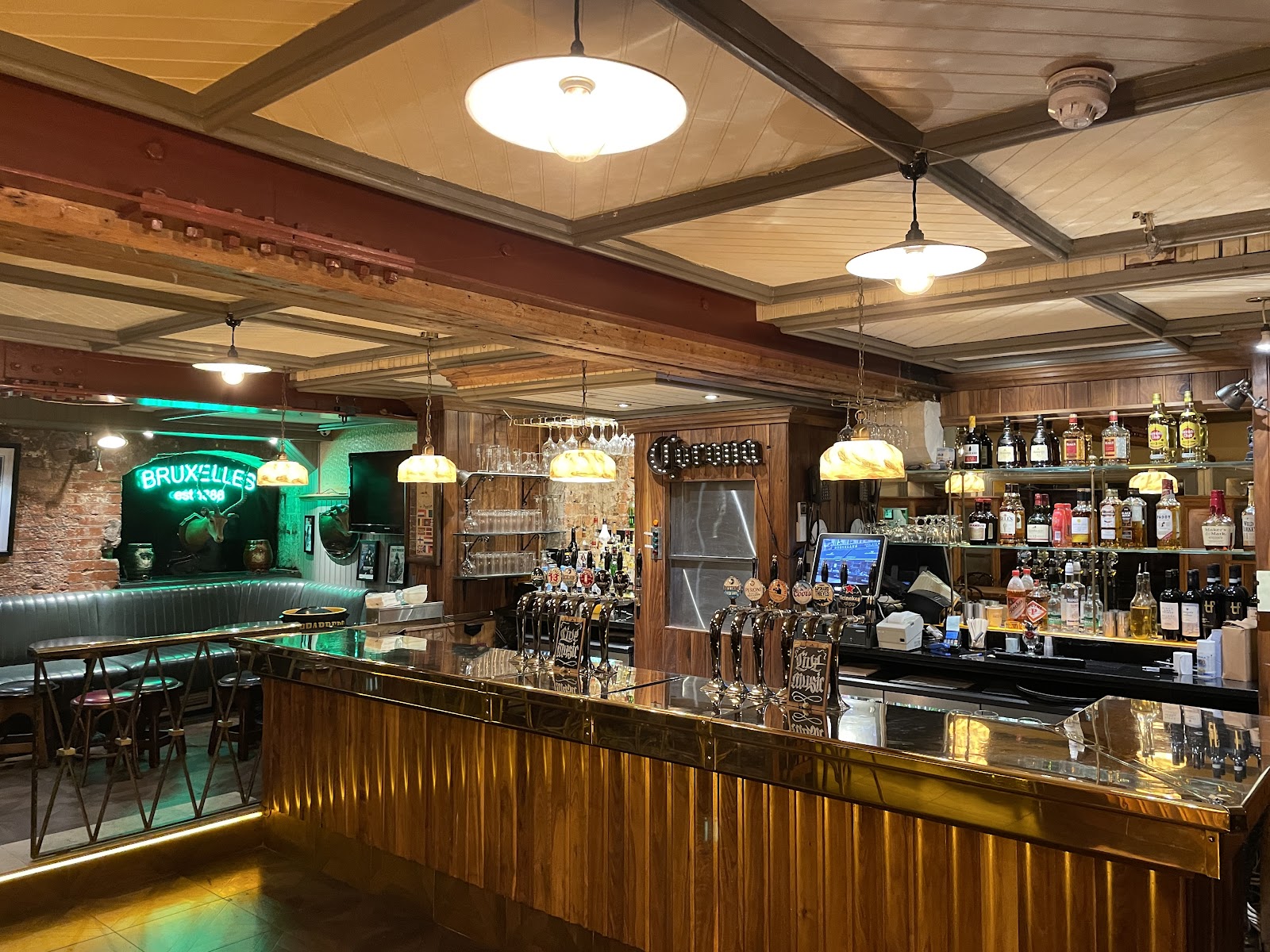 Dark traditional Dublin pub interior with a stage corner and crowded bar at Bruxelles Harry Street