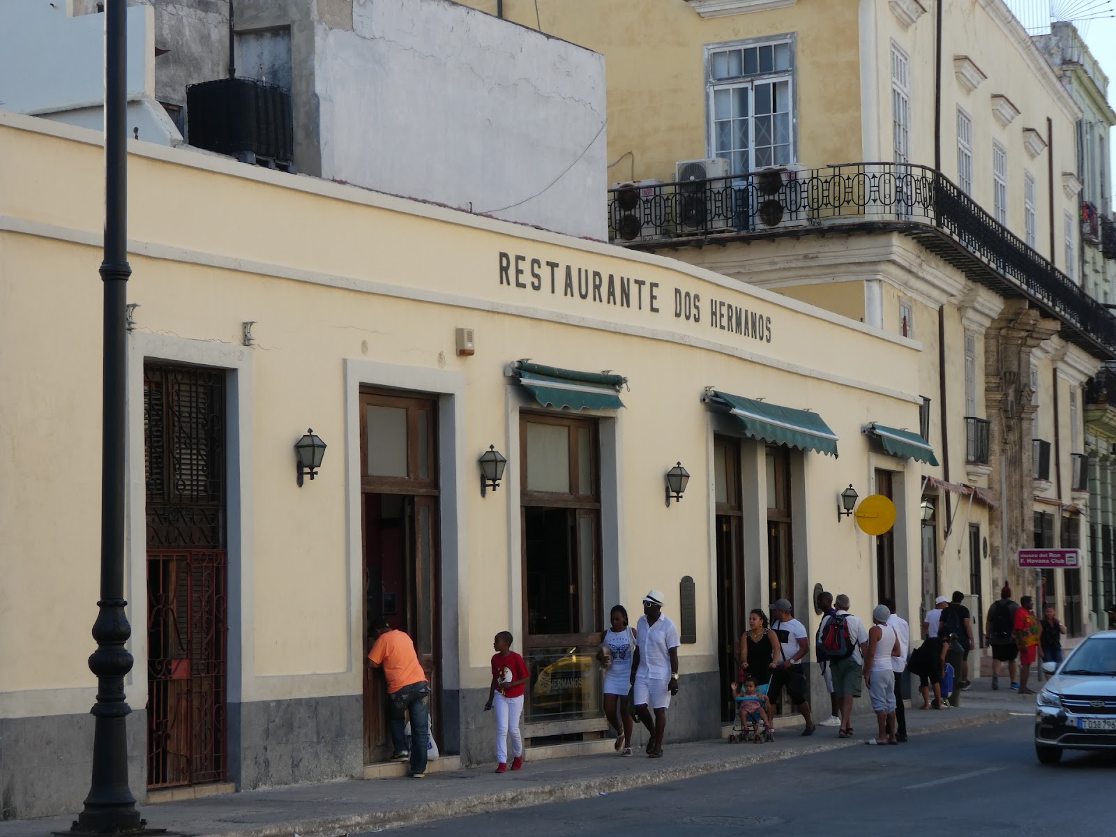 Old wooden tavern interior with high ceilings, similar in mood to Dos Hermanos in Havana