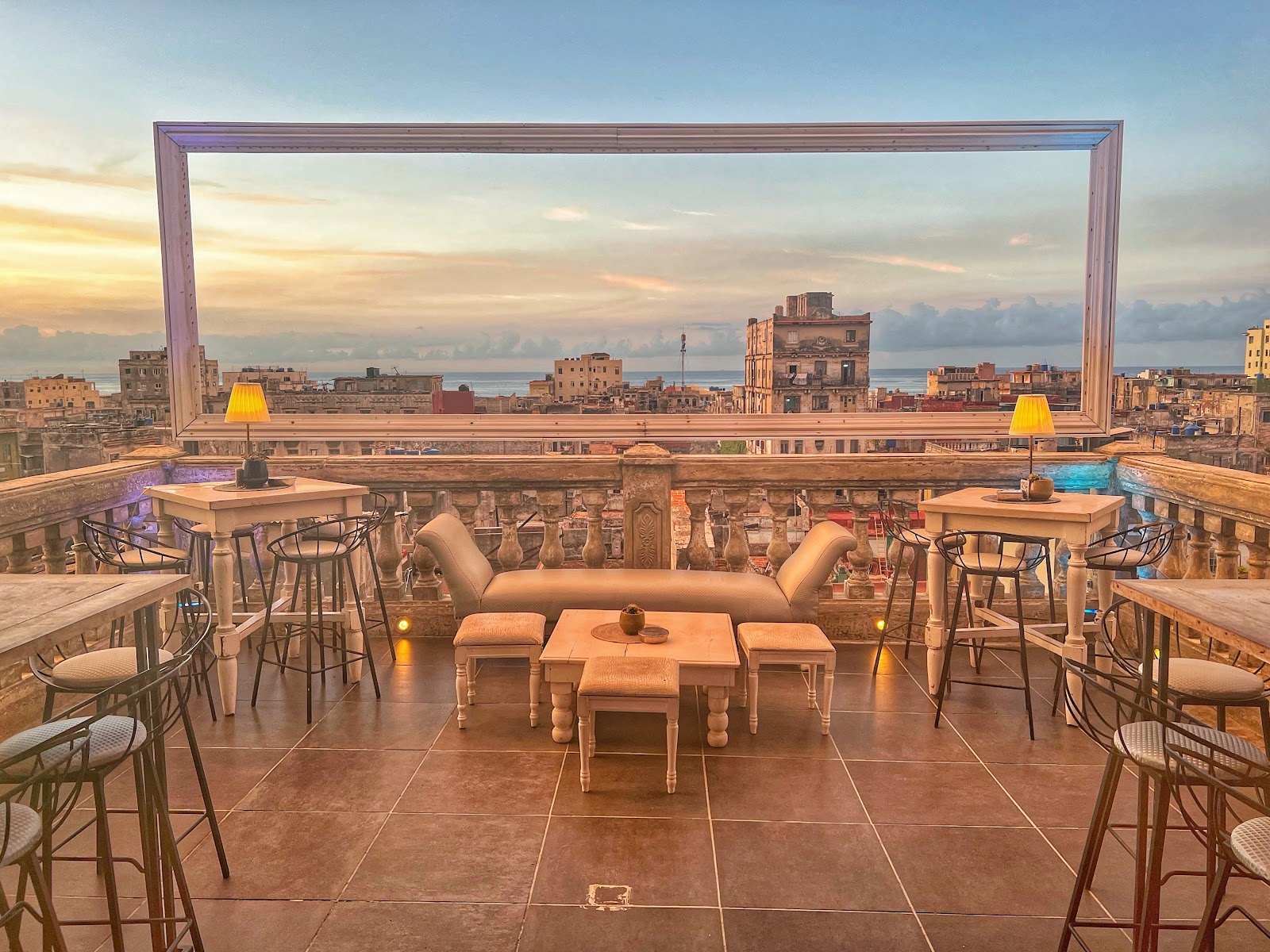 Rooftop bar terrace at dusk with city views, similar in feel to La Guarida Havana