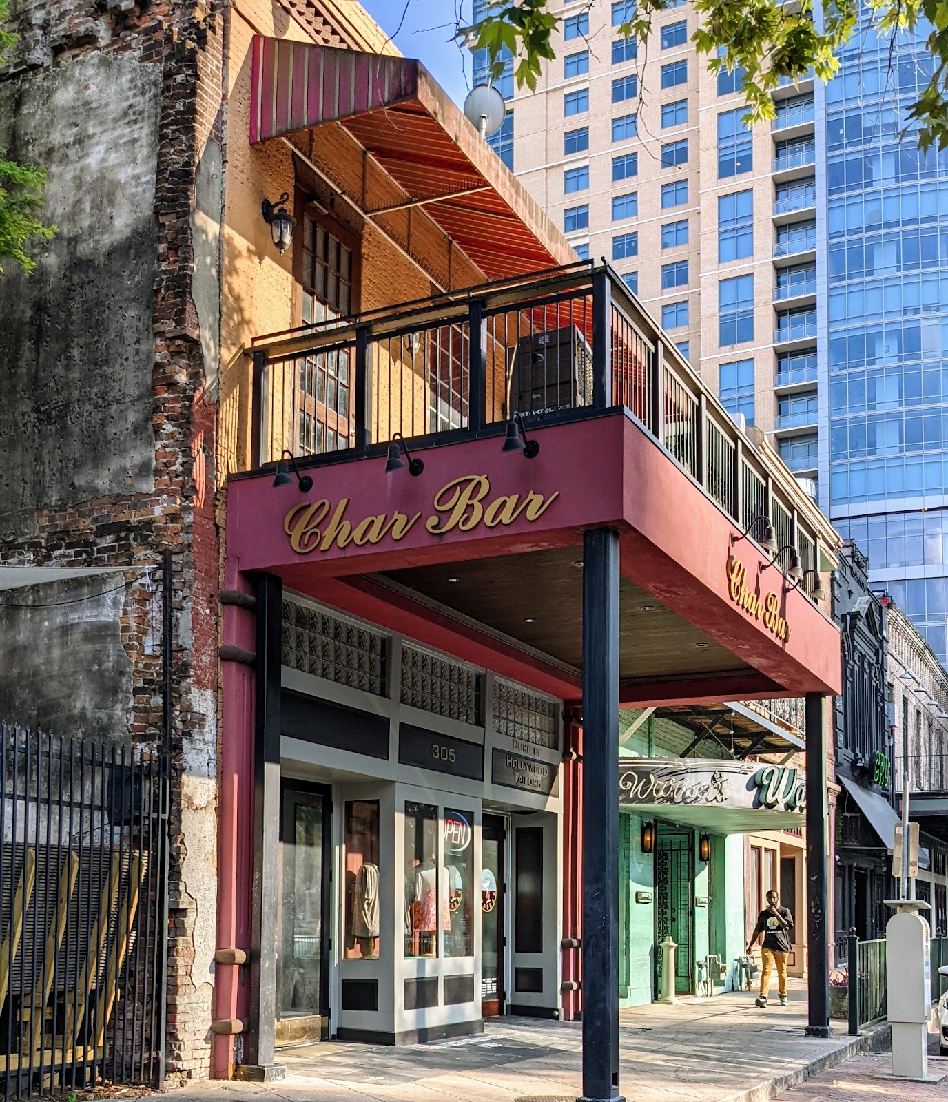 Dimly lit downtown bar with a worn wooden counter and memorabilia on the walls