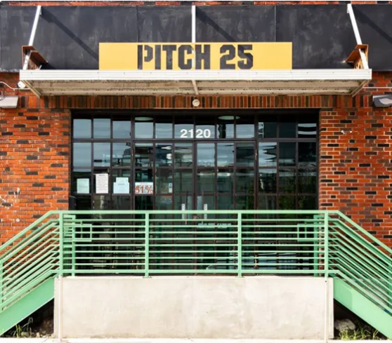 Open-air beer garden with picnic tables and taps in Houston EaDo