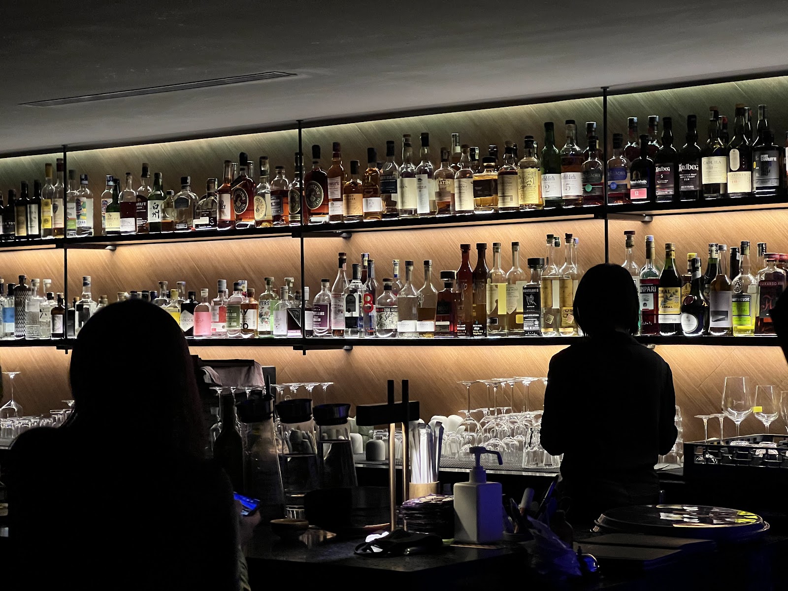 Neon lit modern bar counter at night, similar in feel to Reka:Bar Kuala Lumpur