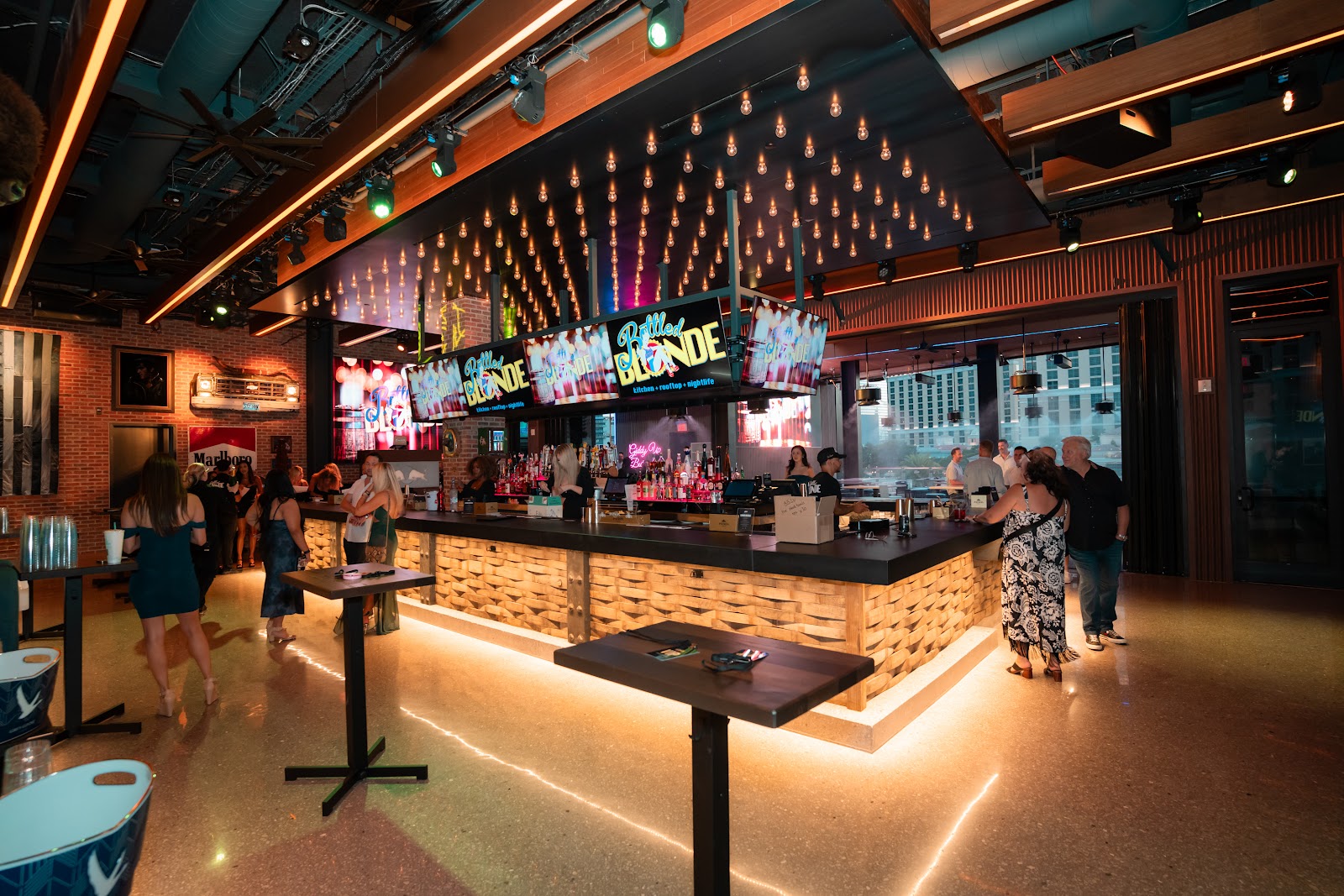 Bottled Blonde Las Vegas interior with screens and a long bar on the Strip