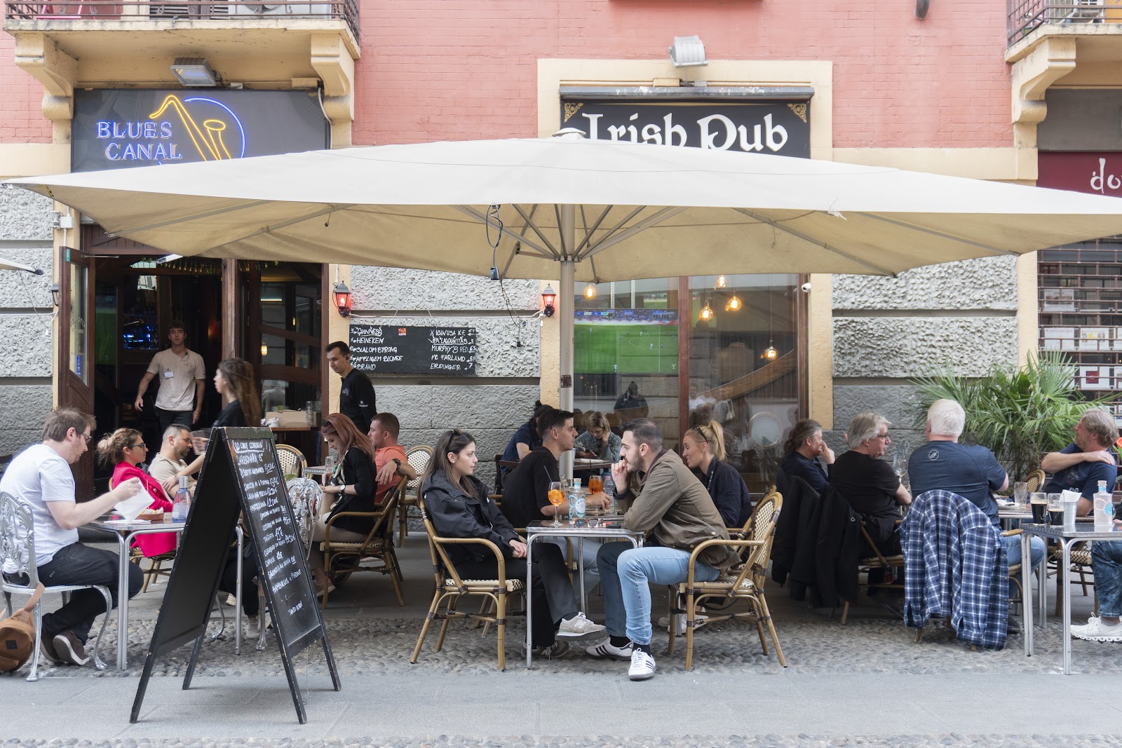 Blues Canal sports pub interior with screens on the Navigli, Milan