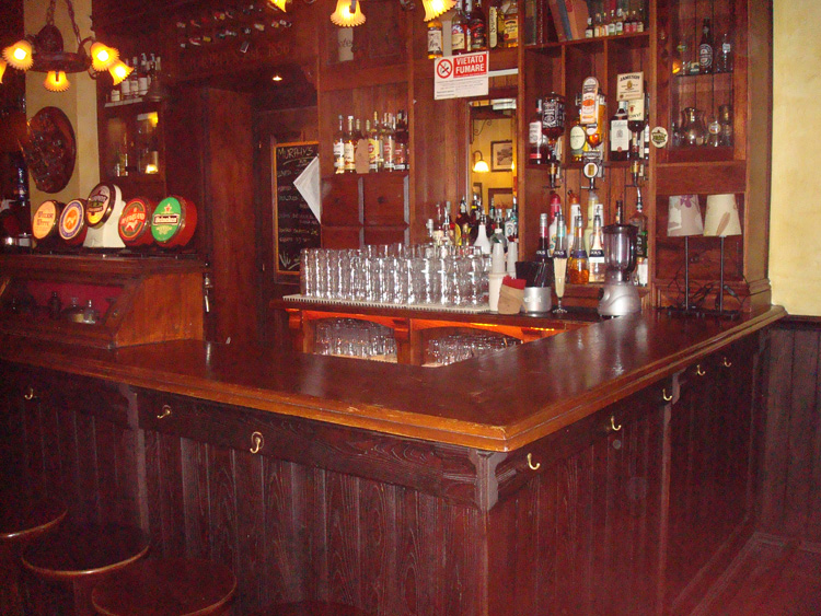 Wood-lined Irish pub interior with screens near the Navigli, Milan