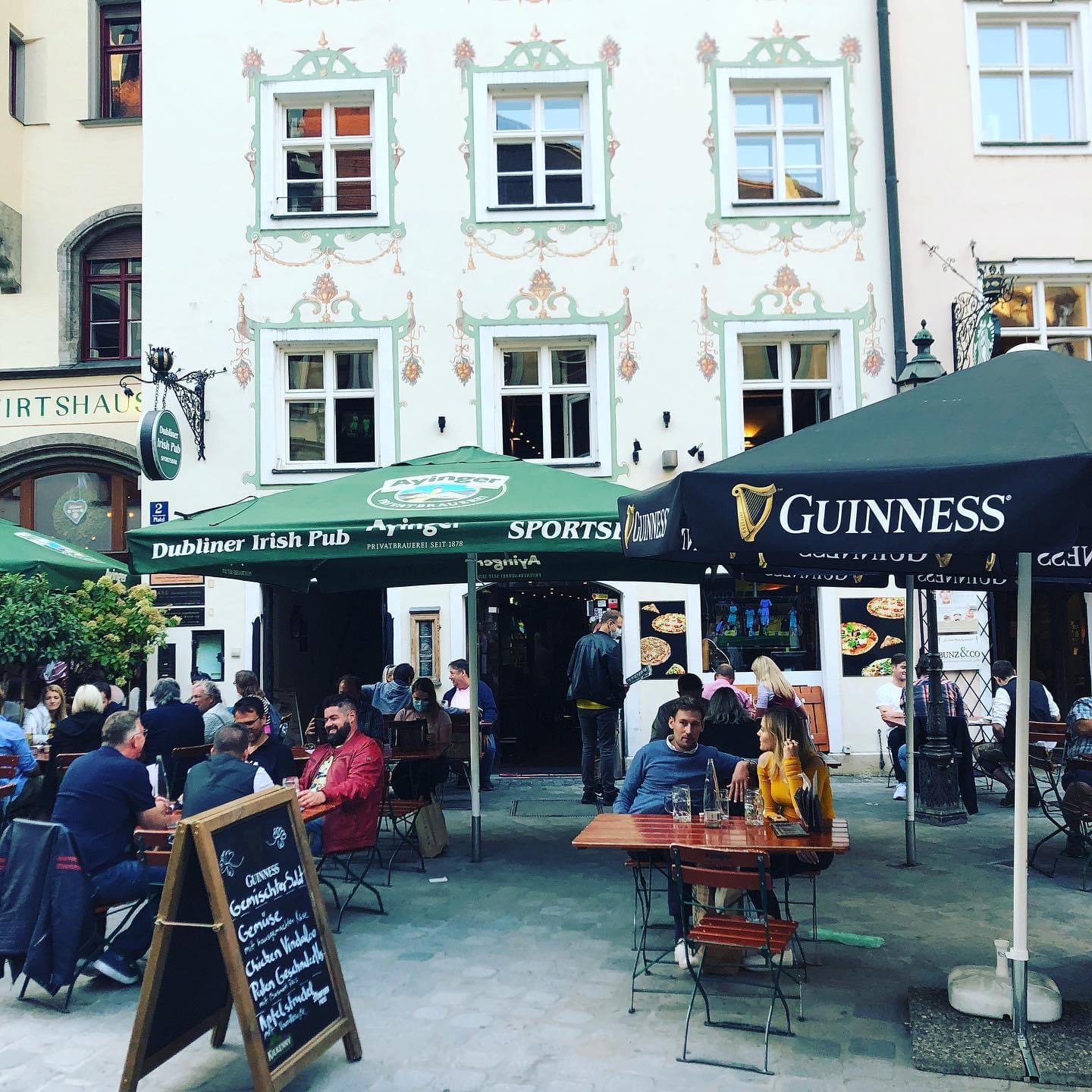 Irish pub interior with wood and screens on Munich's Platzl