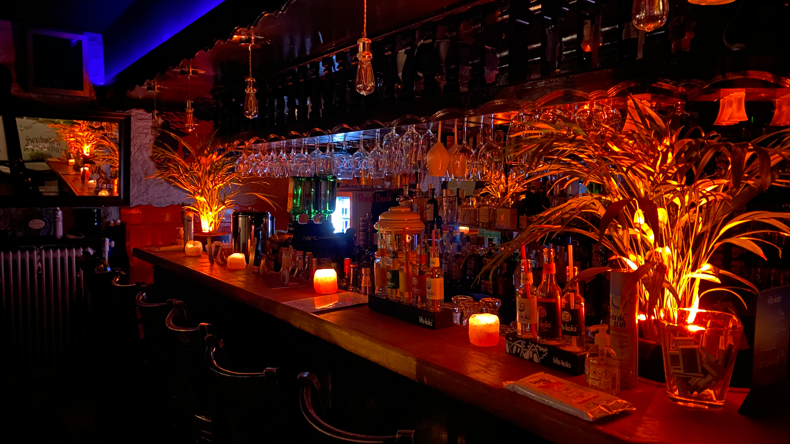 Dim neighbourhood sports bar with a long counter near Goetheplatz Munich
