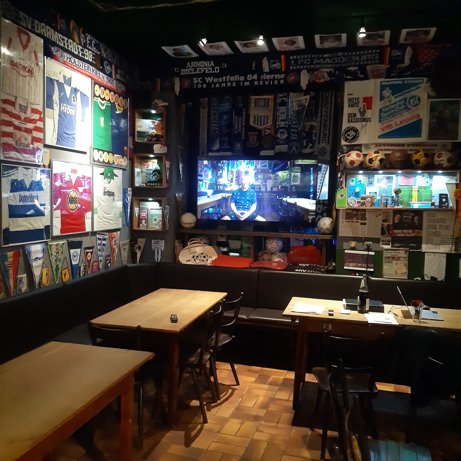 Football pub interior with scarves and screens in Munich's Maxvorstadt
