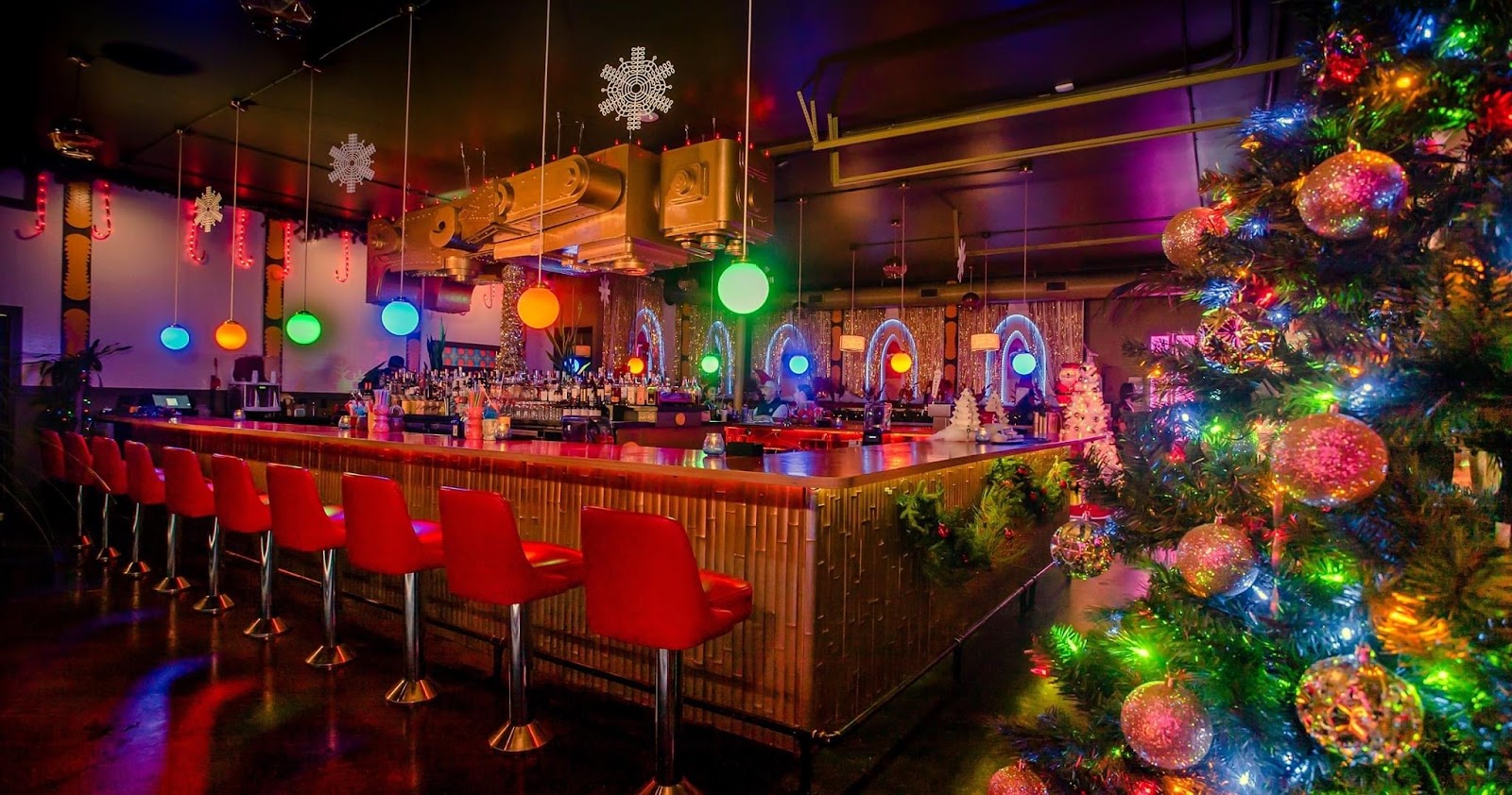 Low-lit tiki bar interior with rum bottles and warm lighting in East Nashville