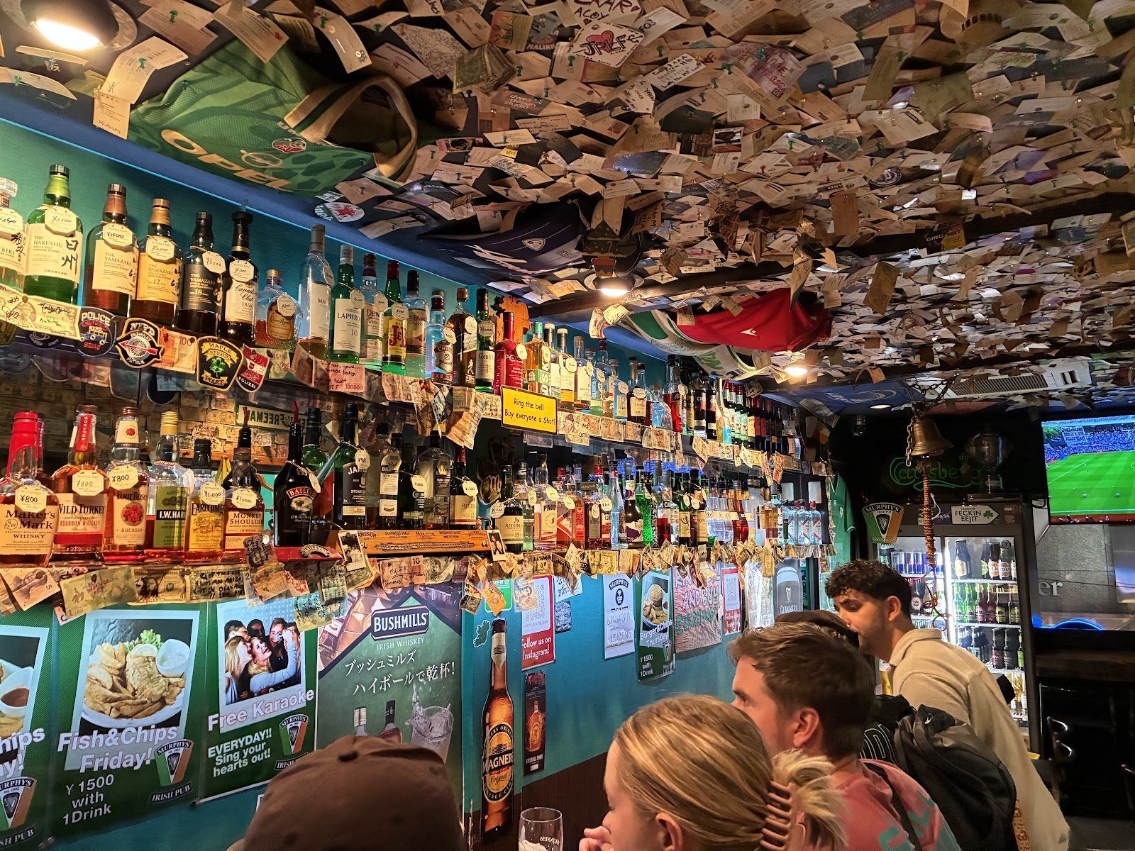 Tropical-themed sports bar with a large screen and high tables, Dotonbori, Osaka