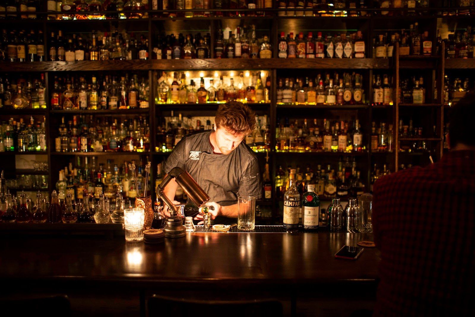 Canon Seattle whiskey bar interior with extensive bottle collection