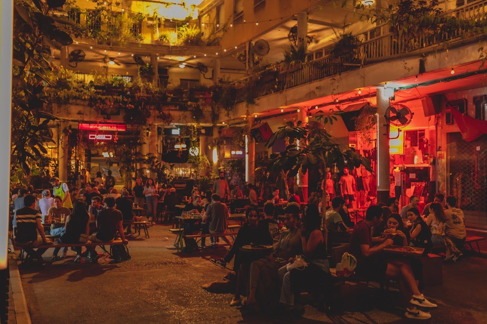 Teder.fm open-air bar on Rothschild Boulevard, Tel Aviv, at night with string lights and a crowd
